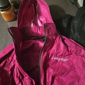 Frogg Toggs Women's Pink Hooded Rain Jacket and Black Pant Set.